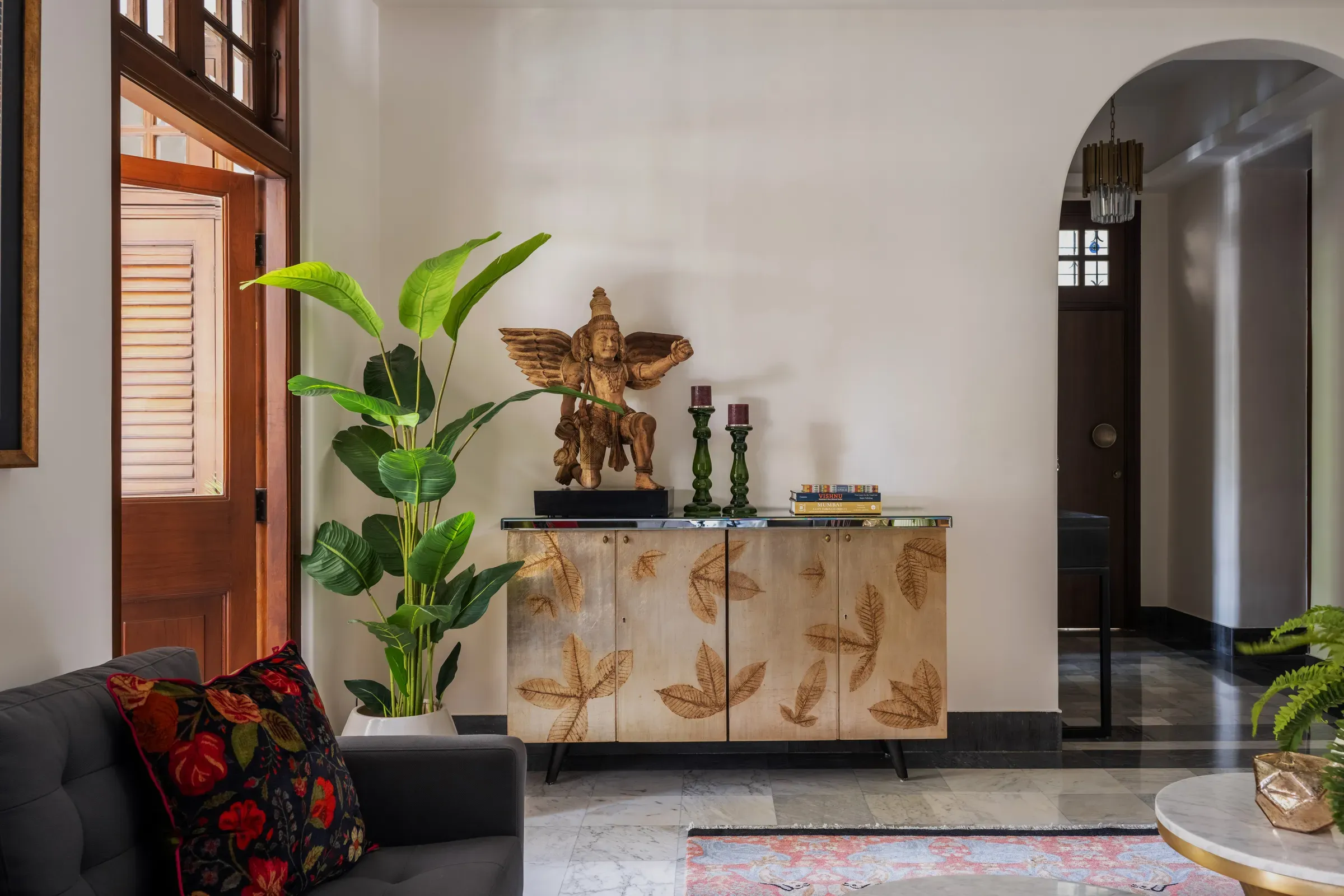 A gilded console and brass figure at Nook Home