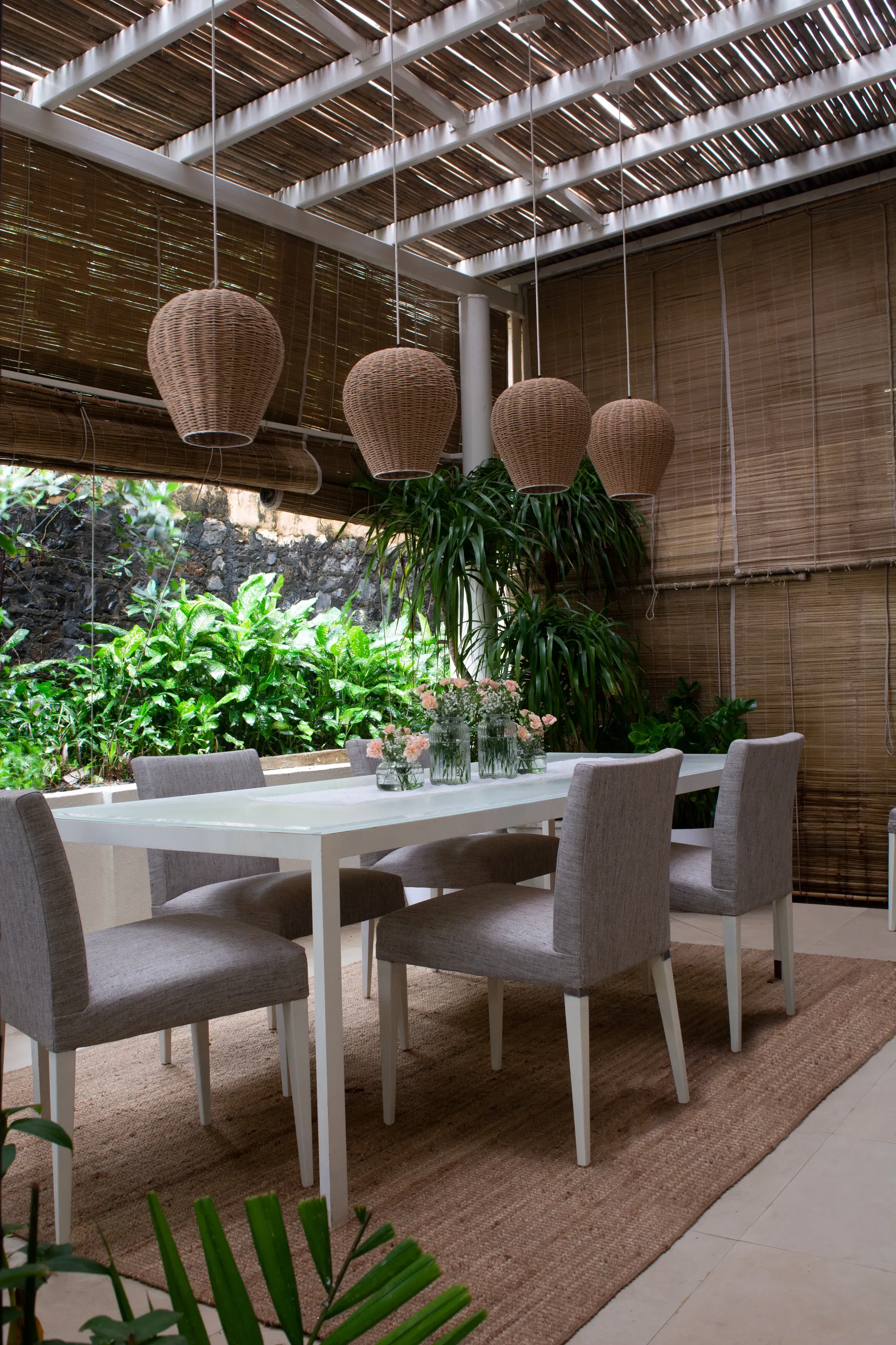 The pergola dining table under bamboo blinds at the Leynwode House