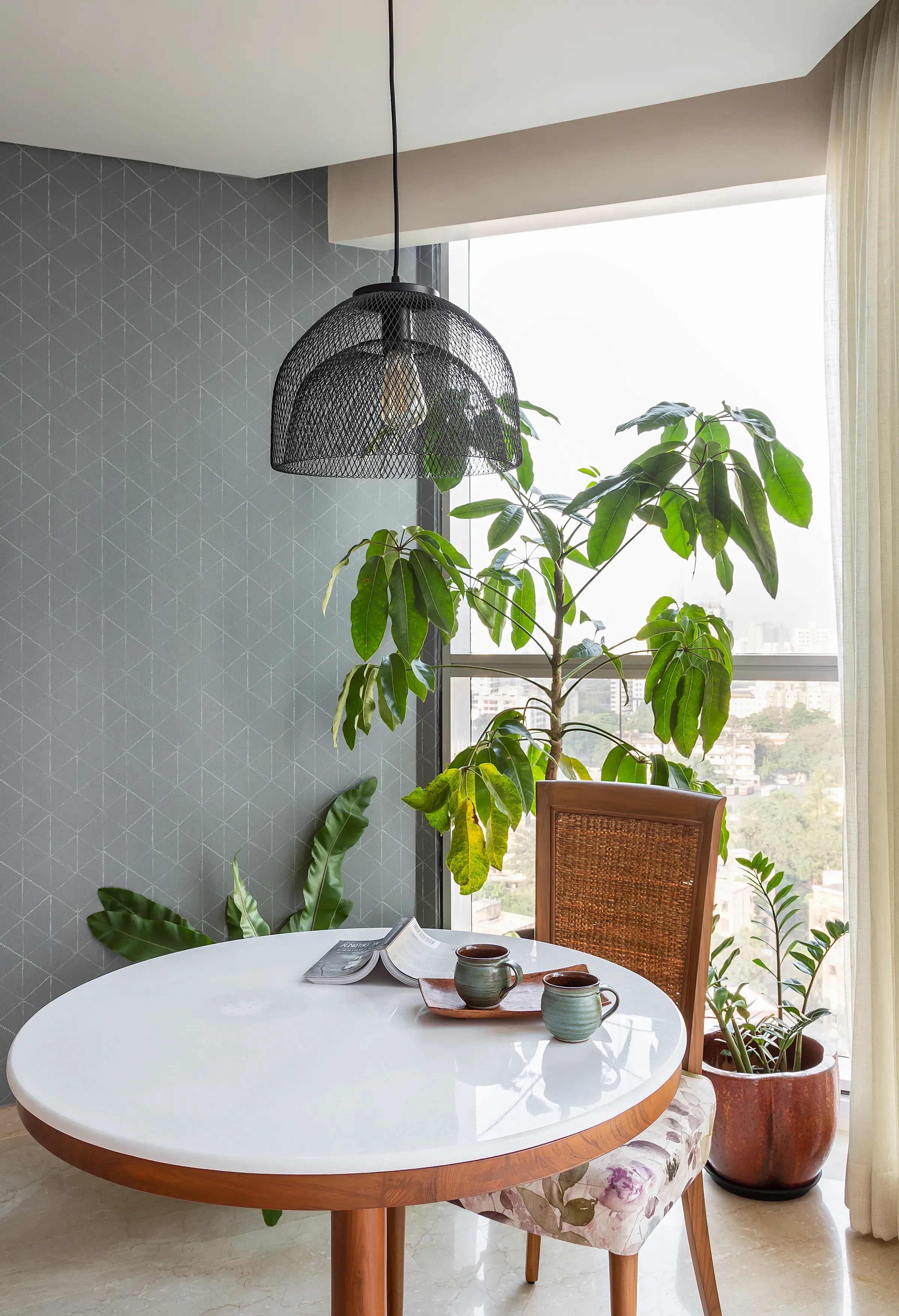 The round table on the planted balcony of the mid-century apartment