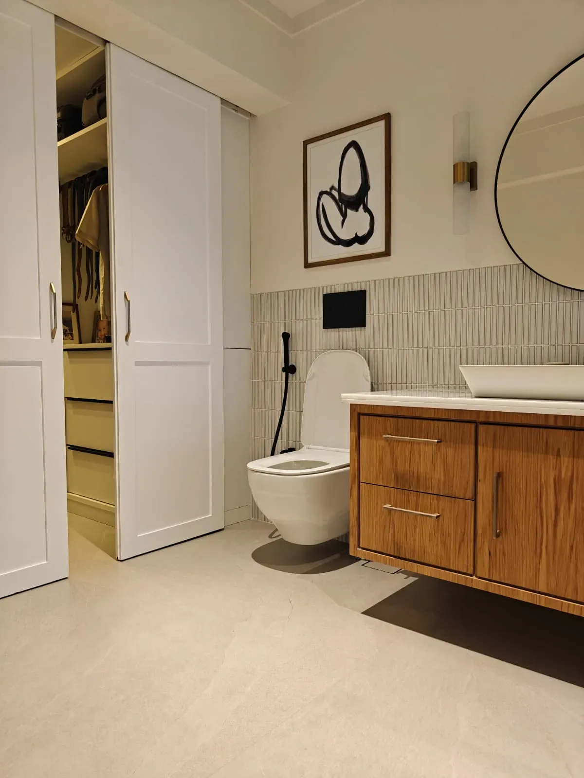 The bathroom, walnut vanity and fluted tile, at the Sterling apartment