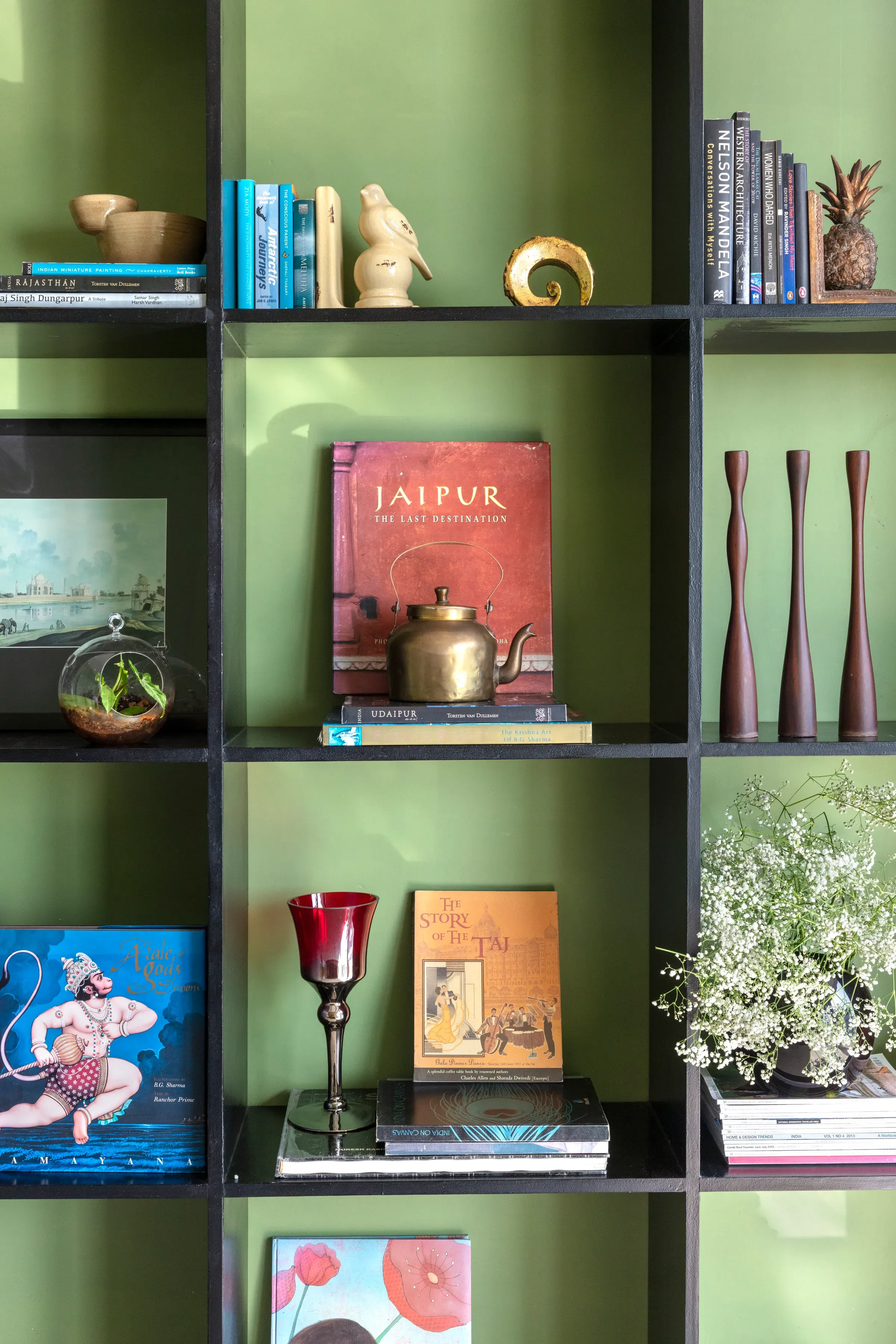 Books and ceramics on the green shelving at The Open Horizon