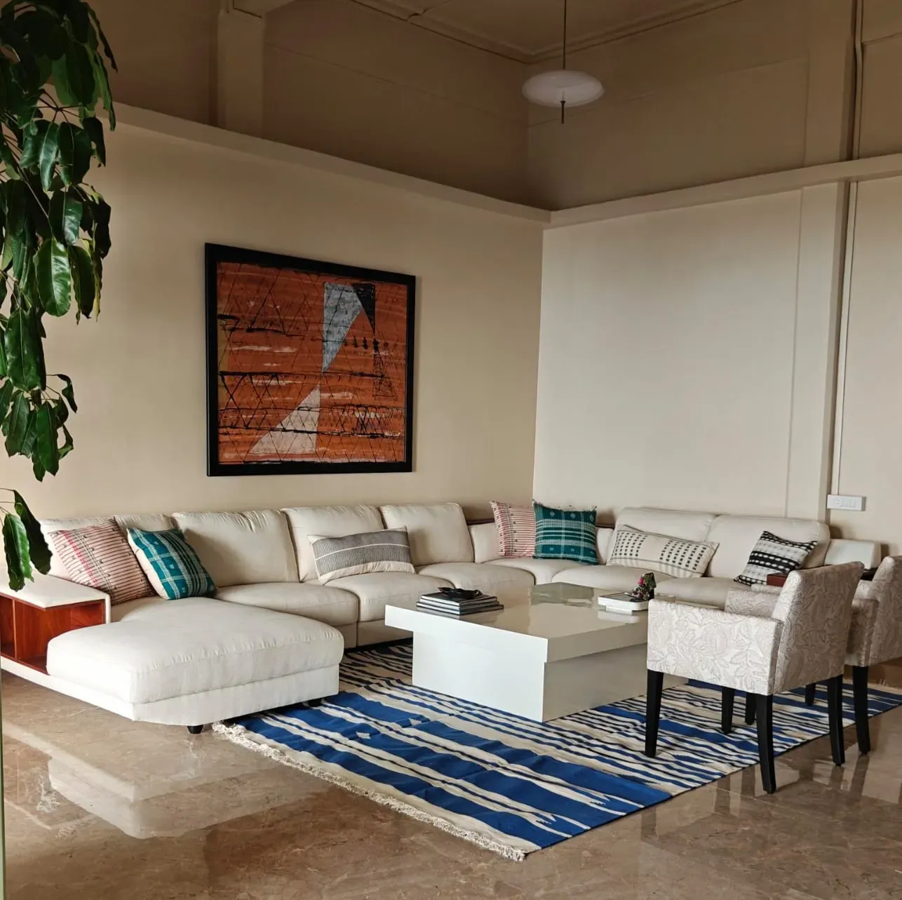 The living room at Tranquila, a white sectional on an indigo dhurrie