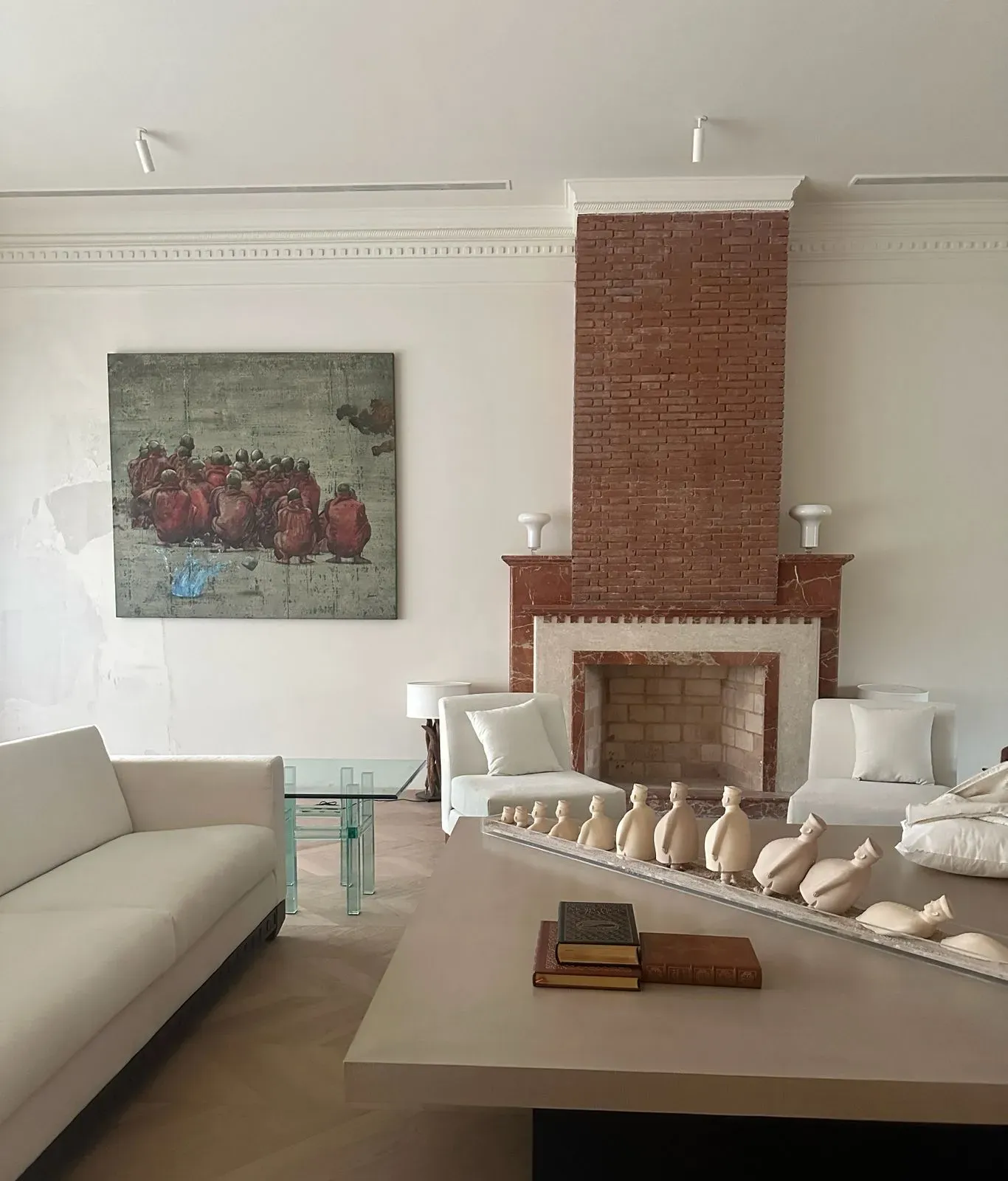 The brick fireplace and its carved figures at the Delhi farmhouse