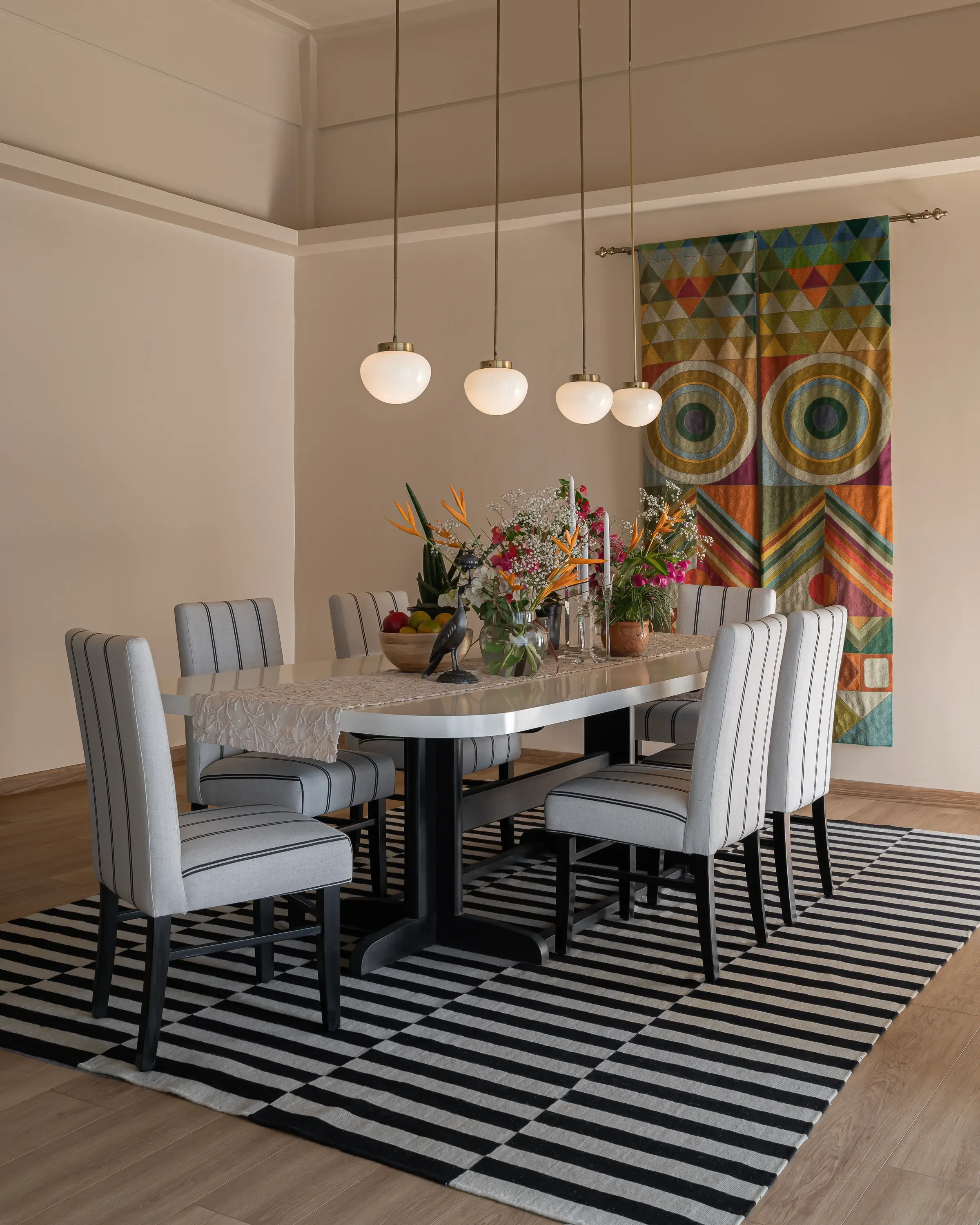 The dining table under milk-glass pendants at Tranquila