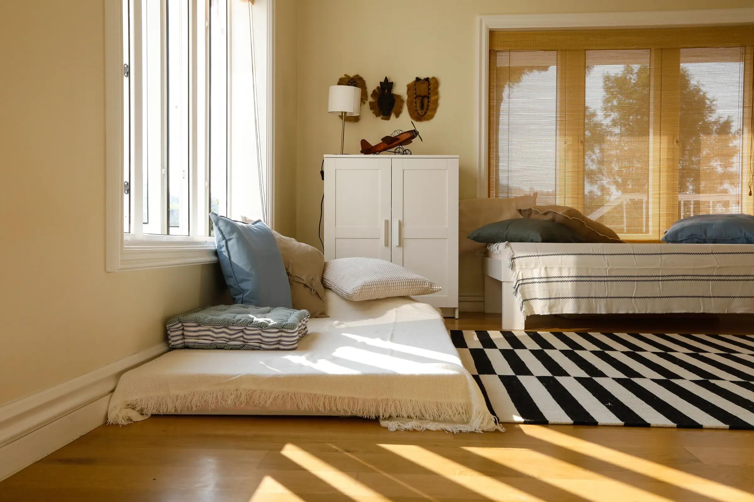 Floor seating and a striped rug in the gadda room
