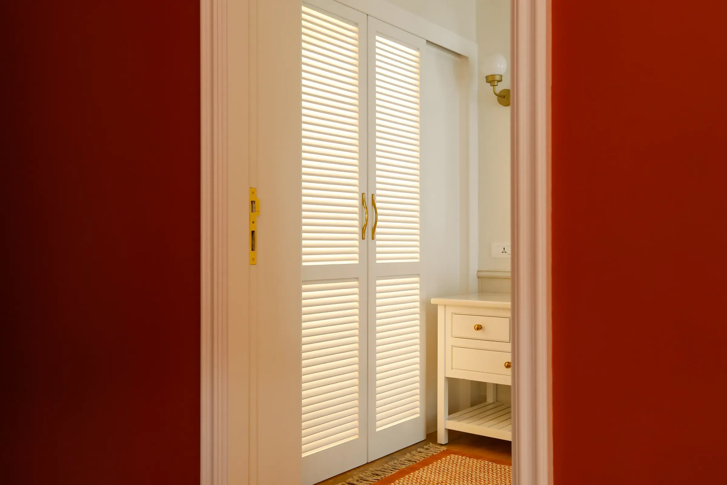 The louvred wardrobe in the terracotta room
