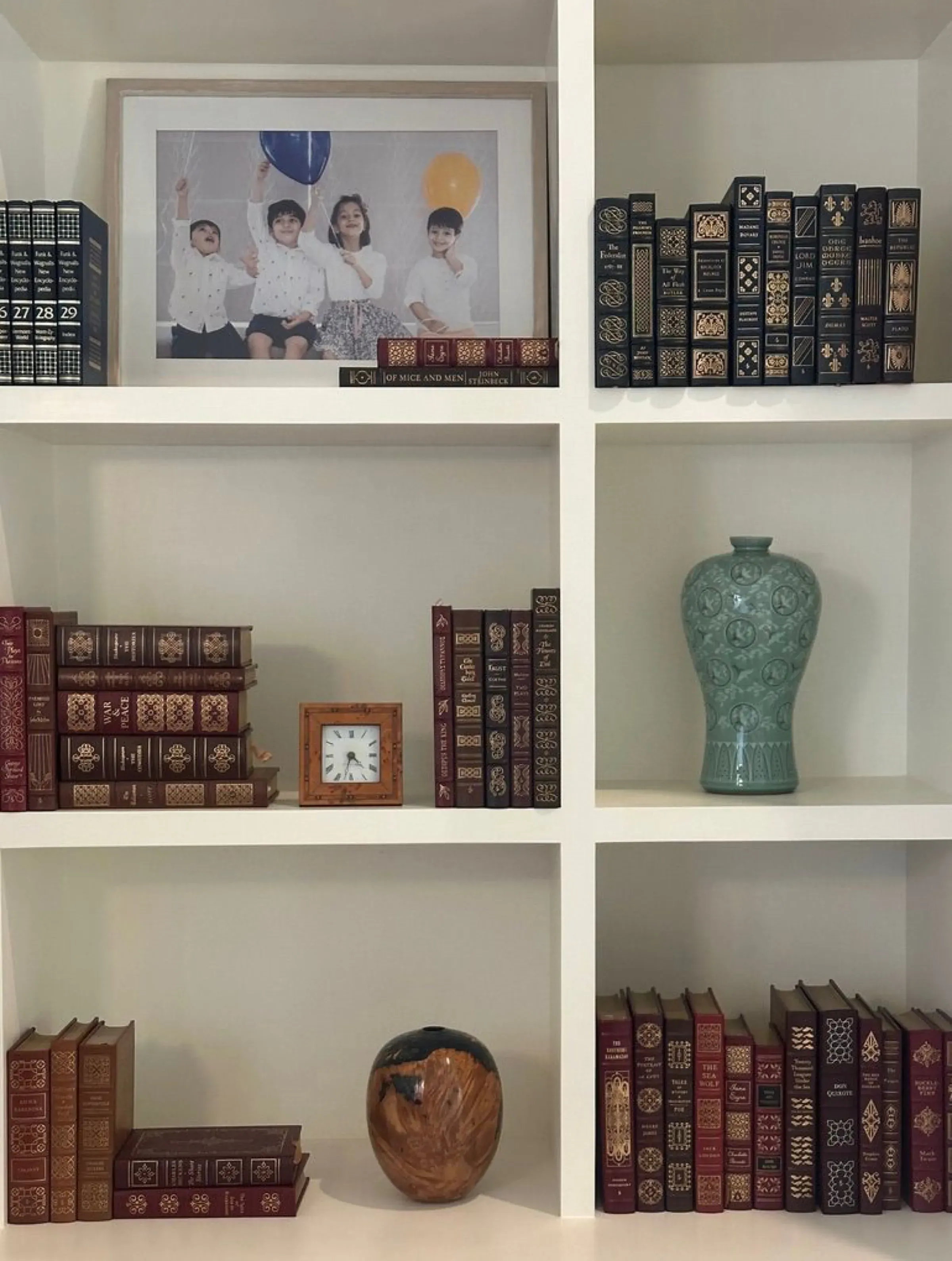 Bookshelf detail with leather-bound books at the Delhi farmhouse