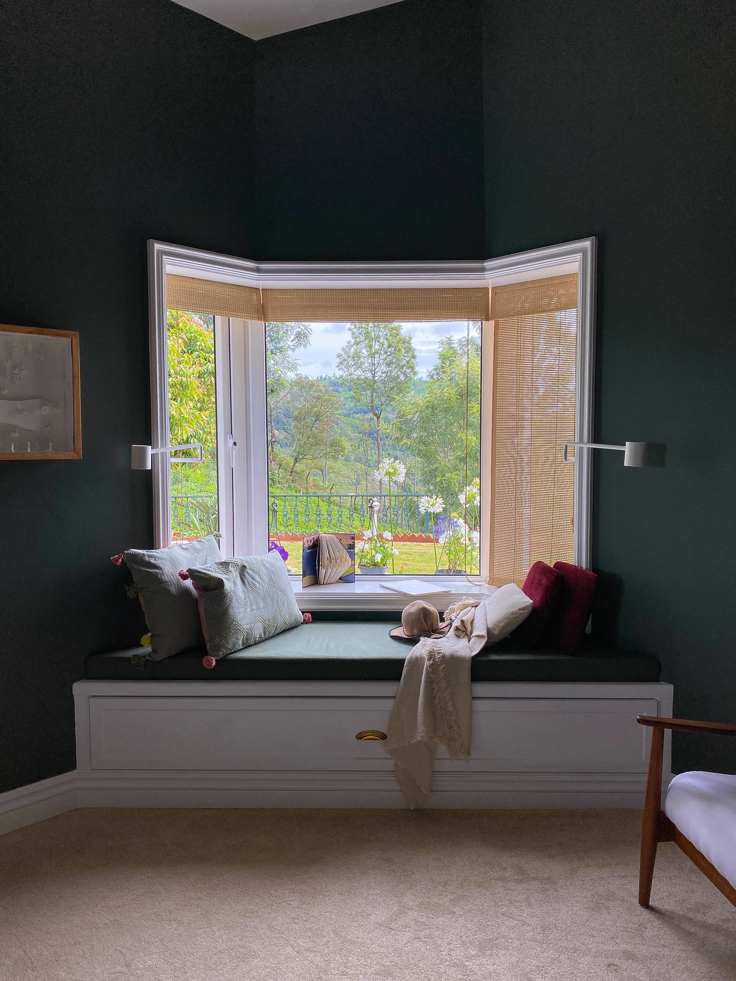 A bedroom corner with a reading lamp at the Coonoor bungalow