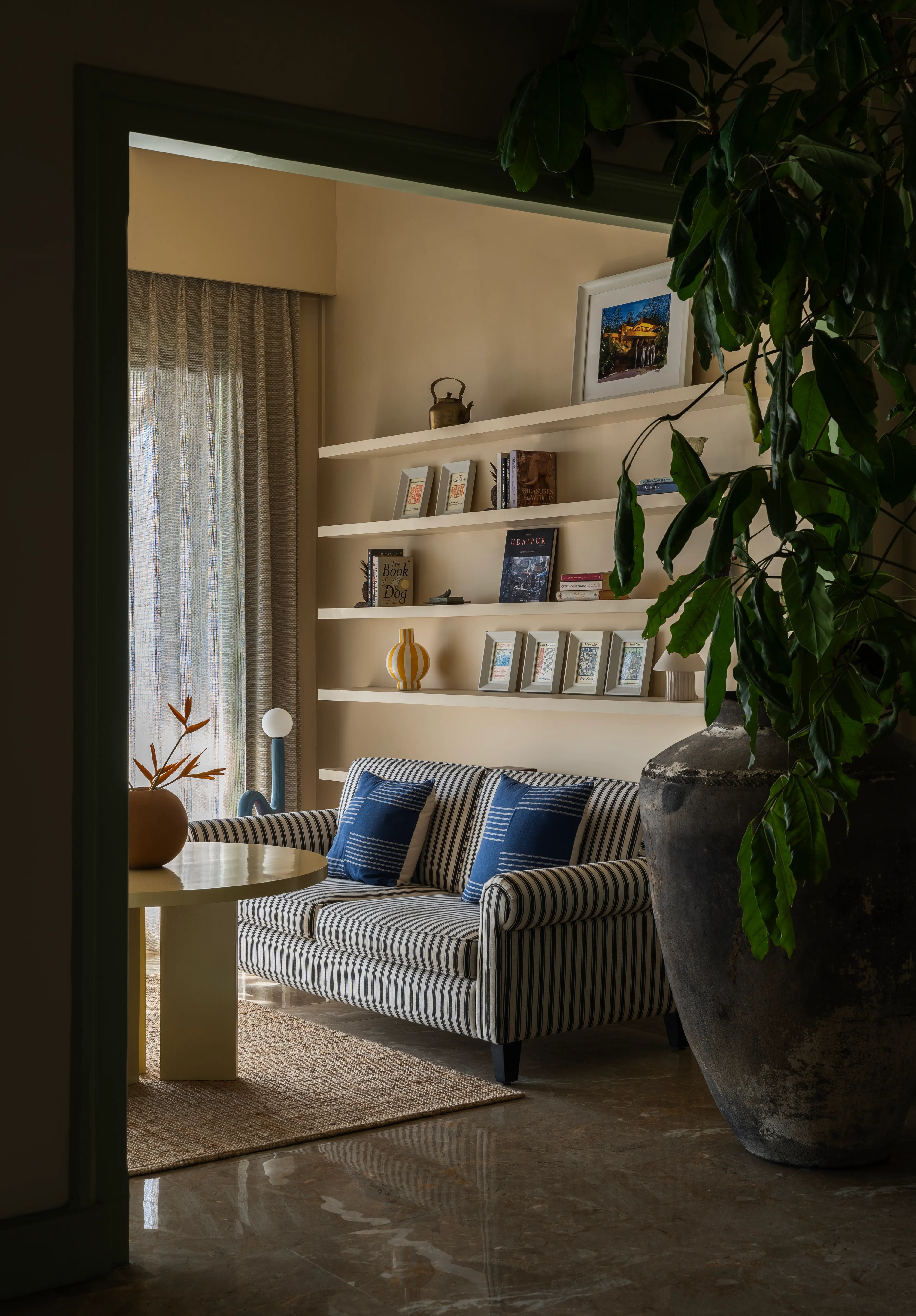 Library nook with blue-striped sofa