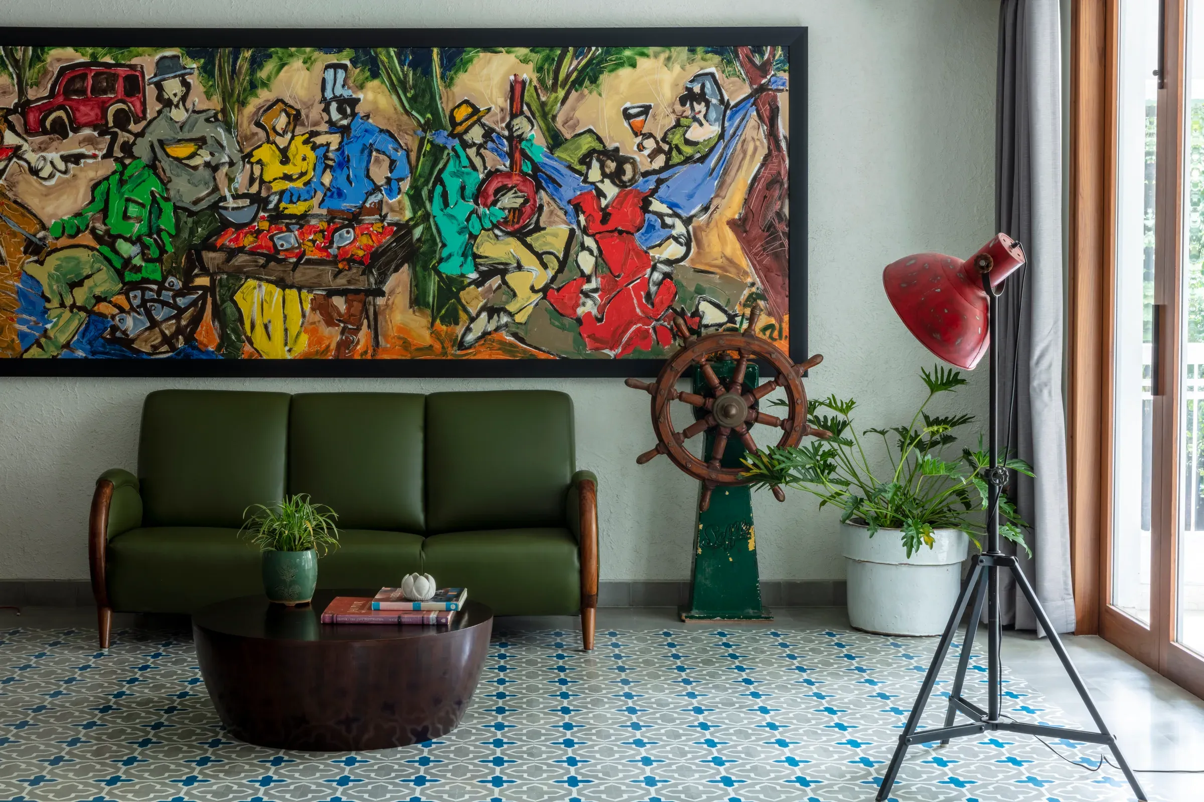 A green sofa, ship’s wheel and patterned tiles in the Prabhadevi party pad by Sonia Gehlot