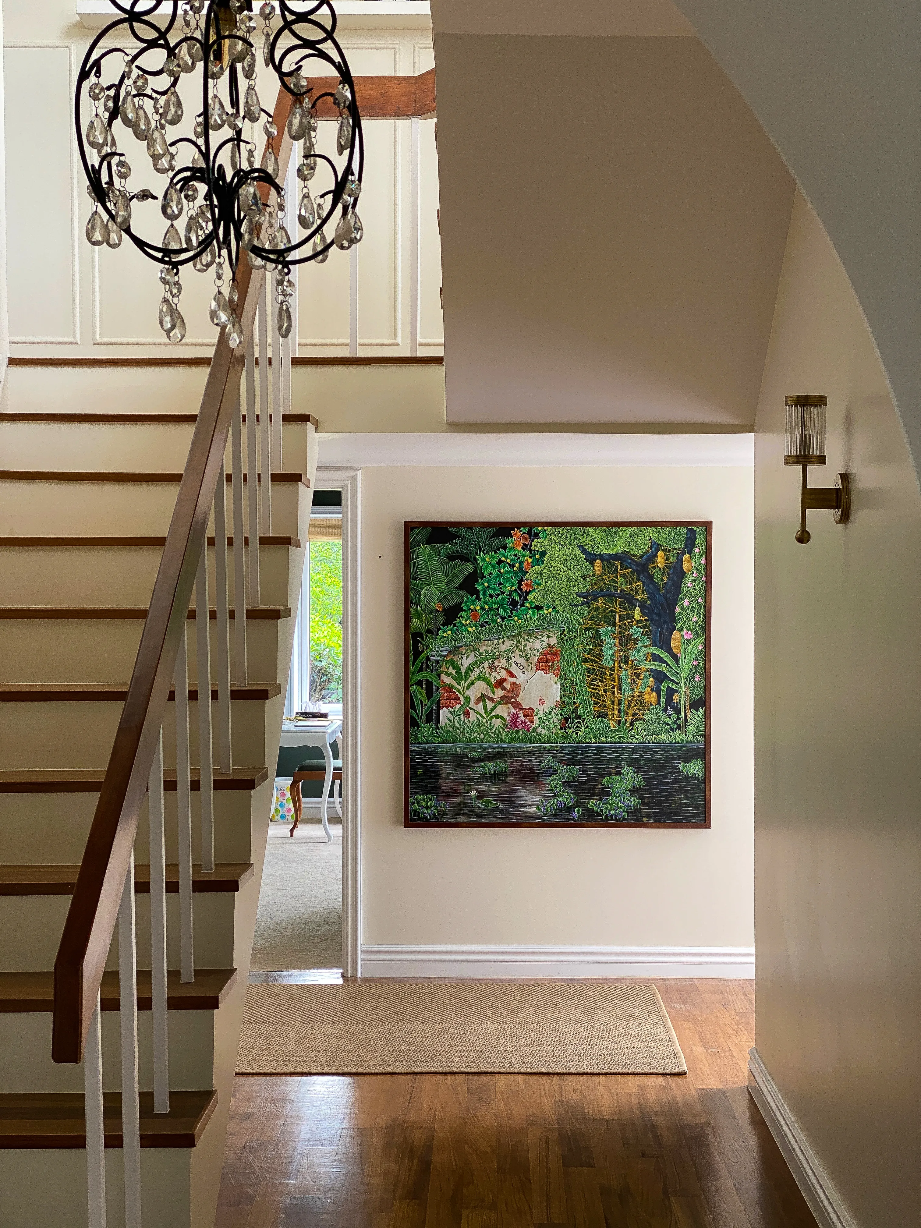 Staircase with chandelier and painting